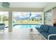 Screened-in lanai featuring a pool and comfortable blue sofa seating at 25 Mariner Ln, Rotonda West, FL 33947