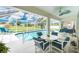 Enjoy outdoor living in this beautiful screened-in pool and patio area with seating at 25 Mariner Ln, Rotonda West, FL 33947