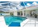 Gorgeous screened in pool with patio furniture, and access to multiple rooms in the home at 25 Mariner Ln, Rotonda West, FL 33947