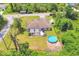 Aerial view of home with a private fenced backyard featuring a patio, pergola, fire pit, and above-ground pool at 2679 Armenia Rd, North Port, FL 34286