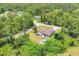 Aerial shot of home nestled among lush greenery, showcasing its private yard with a pergola, fire pit and above-ground pool at 2679 Armenia Rd, North Port, FL 34286