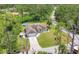 Aerial view of a well-maintained home with a long drive, fenced backyard with above-ground pool and lush tropical landscaping at 2679 Armenia Rd, North Port, FL 34286