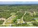 An aerial view of a peaceful community showcases a home with a private pool and beautiful landscaping, surrounded by lush greenery at 2679 Armenia Rd, North Port, FL 34286