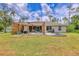 Beautiful backyard featuring a patio, pergola, fire pit, and lush green lawn, perfect for outdoor relaxation and entertaining at 2679 Armenia Rd, North Port, FL 34286