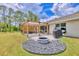 Spacious backyard with a pergola-covered patio, a fire pit, and a well-maintained lawn for outdoor enjoyment at 2679 Armenia Rd, North Port, FL 34286