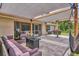 Backyard patio features outdoor seating, a pergola, and a swing with a partially obstructed view of the pool at 2679 Armenia Rd, North Port, FL 34286