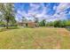 Expansive backyard showcasing a spacious lawn, a modern pergola, and privacy fencing, offering ample room for recreation at 2679 Armenia Rd, North Port, FL 34286