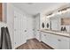 Bright bathroom features dual sinks, multiple linen closets, and a modern design at 2679 Armenia Rd, North Port, FL 34286