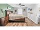 Well-lit bedroom with wood floors, a king-size bed, and mounted tv for relaxation and comfort at 2679 Armenia Rd, North Port, FL 34286