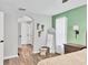 Relaxing bedroom features wood floors, archway to bathroom, and calming green accent wall at 2679 Armenia Rd, North Port, FL 34286