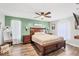 Spacious bedroom features a king-size bed, hardwood floors, and bright green accent wall at 2679 Armenia Rd, North Port, FL 34286