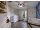Spacious bedroom with a modern ceiling fan, changing table and decor, and natural light from the window at 2679 Armenia Rd, North Port, FL 34286
