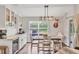 Charming dining area featuring modern light fixture, backyard view, blending indoor and outdoor living at 2679 Armenia Rd, North Port, FL 34286