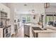 Open-concept kitchen with marble counters, stainless steel appliances, and backyard view, creating a warm space at 2679 Armenia Rd, North Port, FL 34286
