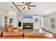Well-lit living room boasts a modern fireplace, neutral walls, and elegant wood-look floors at 2679 Armenia Rd, North Port, FL 34286