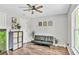 Bright living room with wood flooring and a ceiling fan, complemented by stylish seating and decor at 2679 Armenia Rd, North Port, FL 34286
