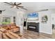 Spacious living room with an inviting sofa, electric fireplace, and wood-look flooring at 2679 Armenia Rd, North Port, FL 34286