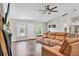 Bright living room featuring a comfortable sectional sofa, modern fireplace, and wood-look floors at 2679 Armenia Rd, North Port, FL 34286