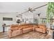 Open-concept living room with a large sectional sofa and views of the modern kitchen at 2679 Armenia Rd, North Port, FL 34286