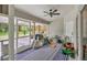 Enclosed patio featuring a play area, ceiling fan, and outdoor seating overlooking the backyard at 2679 Armenia Rd, North Port, FL 34286