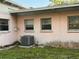 Exterior home showcasing a pink wall and an AC unit at 2911 Novus St, Sarasota, FL 34237