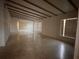 Living room featuring a beamed ceiling and terrazzo flooring at 2911 Novus St, Sarasota, FL 34237