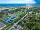 Breathtaking aerial view of a community with lush greenery, tennis courts, and waterfront property at 348 W Wentworth St, Englewood, FL 34223
