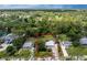 An aerial view captures a quaint single-story home framed by lush greenery and a spacious yard at 348 W Wentworth St, Englewood, FL 34223