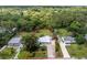 Aerial view of a single-story home with a large yard and mature trees surrounding the property at 348 W Wentworth St, Englewood, FL 34223