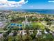 An aerial shot shows a compact single-story home close to tennis courts, water access, and verdant surroundings at 348 W Wentworth St, Englewood, FL 34223