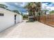 Well maintained backyard with gravel, pavers, fencing, shed, and a small wooden potting table at 348 W Wentworth St, Englewood, FL 34223