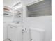 An all-white bathroom with a vanity, toilet, and lighting at 348 W Wentworth St, Englewood, FL 34223
