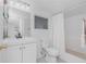 A well-lit bathroom featuring all white fixtures and tile flooring at 348 W Wentworth St, Englewood, FL 34223