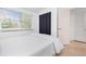 Bright bedroom with a large window, hardwood floors, and a white comforter at 348 W Wentworth St, Englewood, FL 34223