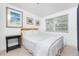 A bright bedroom with terrazzo floors and a comfortable bed at 348 W Wentworth St, Englewood, FL 34223