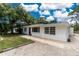 Charming home exterior featuring a new dark blue front door, modern windows, and tidy landscaping at 348 W Wentworth St, Englewood, FL 34223