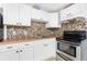 A well-lit kitchen featuring stainless steel appliances, tiled backsplash and wood countertops at 348 W Wentworth St, Englewood, FL 34223