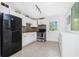 Functional kitchen with stainless steel appliances, white cabinets, and neutral backsplash at 348 W Wentworth St, Englewood, FL 34223