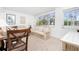 Cozy living room features a comfortable sofa, dining table, and natural light through the large windows at 348 W Wentworth St, Englewood, FL 34223
