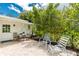 Cozy brick patio with outdoor seating, surrounded by lush landscaping, perfect for relaxing outdoors at 348 W Wentworth St, Englewood, FL 34223