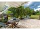 Covered patio with a table, chairs, and lush greenery at 348 W Wentworth St, Englewood, FL 34223