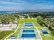 Aerial view of local tennis courts, showcasing manicured courts, lush landscaping, and open space for recreation at 348 W Wentworth St, Englewood, FL 34223