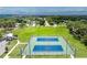 View of public tennis courts surrounded by green space, pathways, and a canopy of trees for outdoor enjoyment at 348 W Wentworth St, Englewood, FL 34223