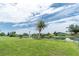 Spacious backyard with a canal view, mature landscaping, and a white heron at 39 Caddy Rd, Rotonda West, FL 33947