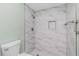 Bathroom shower featuring marble look tile, shower caddy and updated shower head at 39 Caddy Rd, Rotonda West, FL 33947