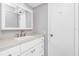 Bathroom vanity with white cabinetry, stone countertop and updated faucet at 39 Caddy Rd, Rotonda West, FL 33947