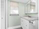 Bathroom featuring updated cabinetry, tile floors and updated fixtures at 39 Caddy Rd, Rotonda West, FL 33947