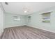 Bedroom featuring updated wood flooring, ceiling fan and two windows at 39 Caddy Rd, Rotonda West, FL 33947