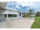 Exterior featuring a front patio with awning-covered windows, blue front door, and desert landscaping at 39 Caddy Rd, Rotonda West, FL 33947