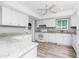Updated kitchen with white cabinets, granite countertops, and stainless appliances at 39 Caddy Rd, Rotonda West, FL 33947